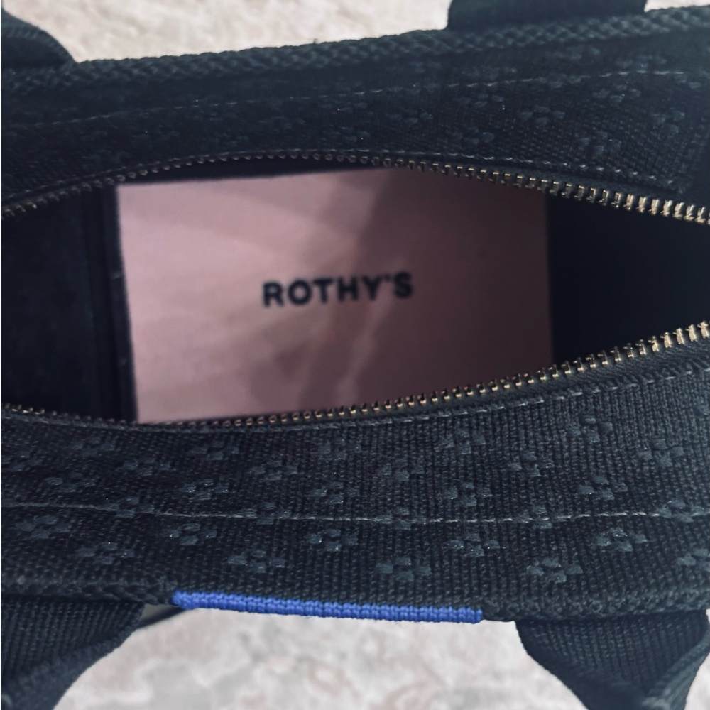 Rothy's Black Backpack with Textured Fabric and Blue Accent